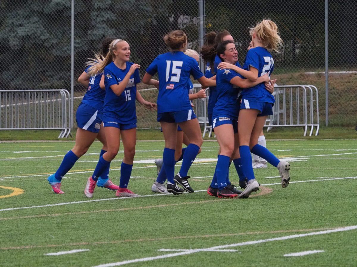 Girls Varisty Soccer Team celebrating after a goal!