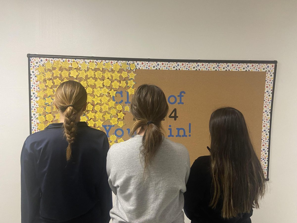 Students view the college admissions bulletin board. 