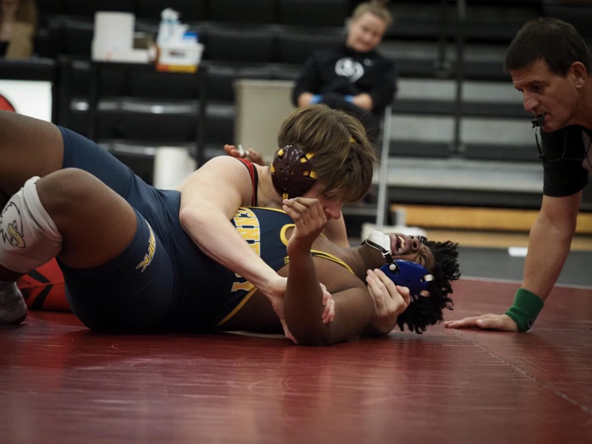 Senior Jack Blaylock , captain of the AHA/Richfield wrestling team, pins his opponent for a win.